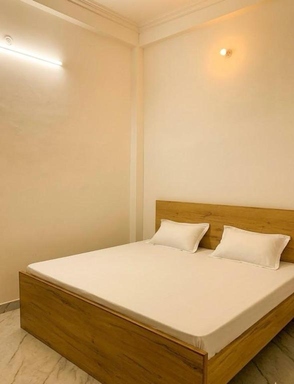 a bed with two pillows on it in a room at Baloonrooms in Gorakhpur