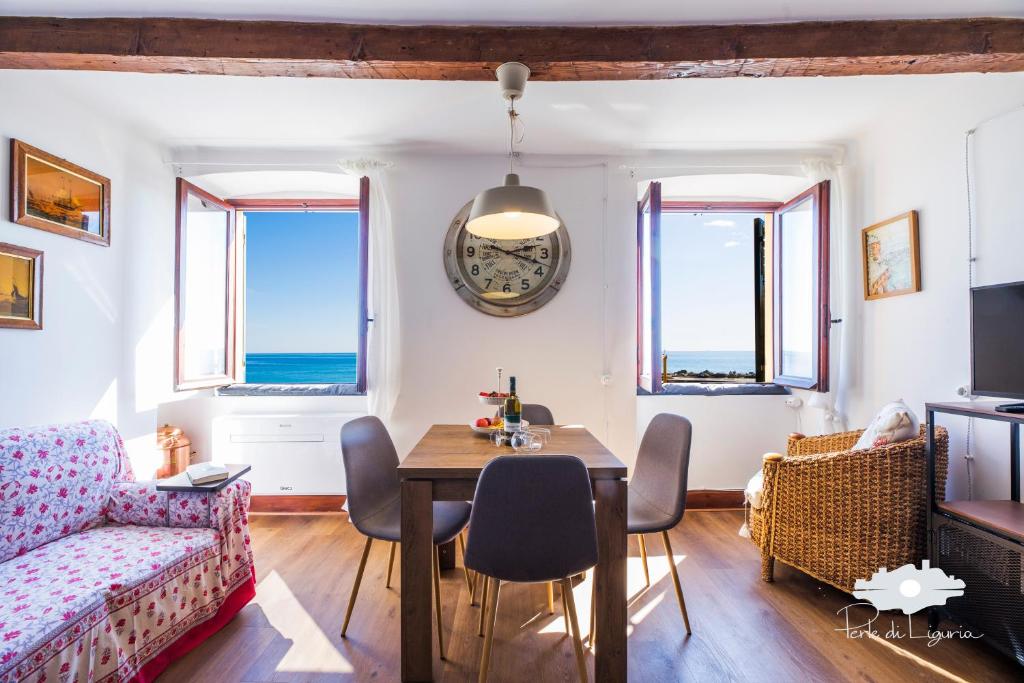 a living room with a table and a couch at La cabina del capitano in Bogliasco