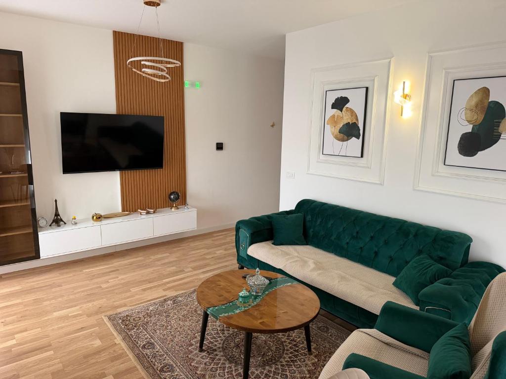 a living room with a green couch and a table at Lux stan in Bar