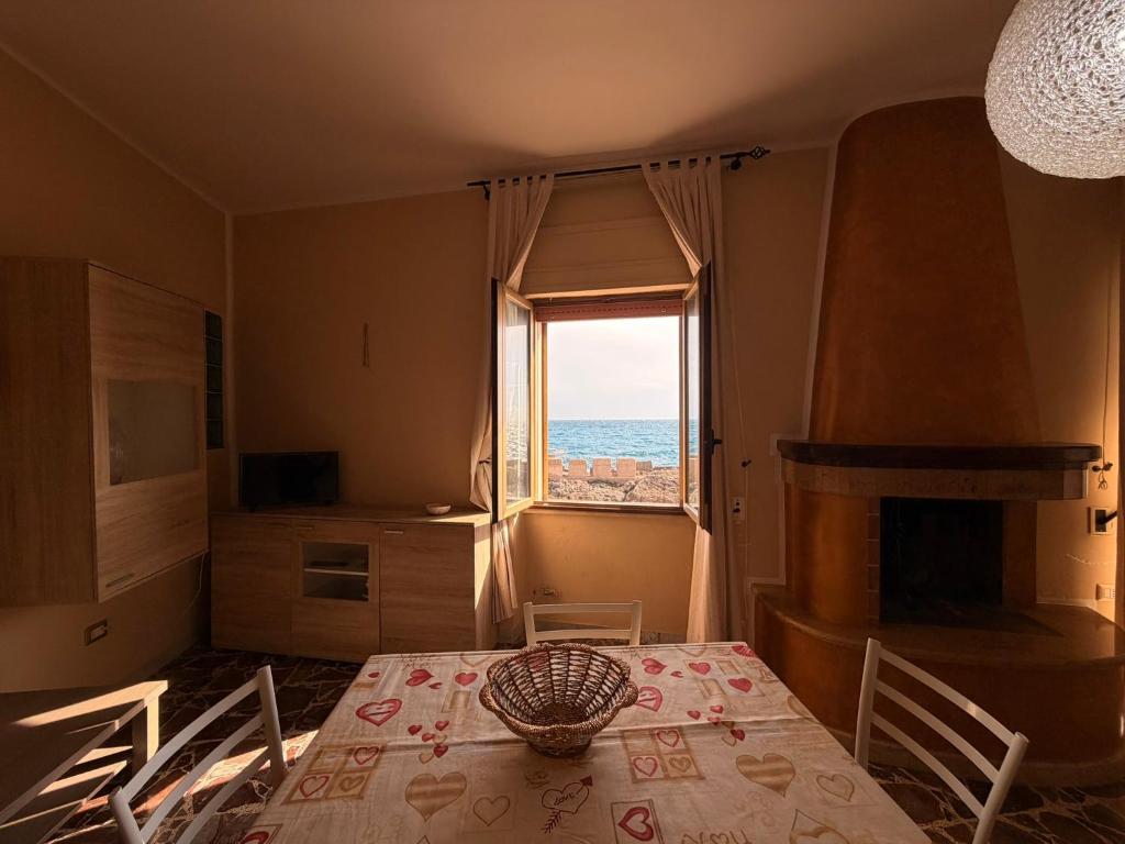 a dining room with a table and a view of the ocean at Tra Mare e Relax in Gallipoli