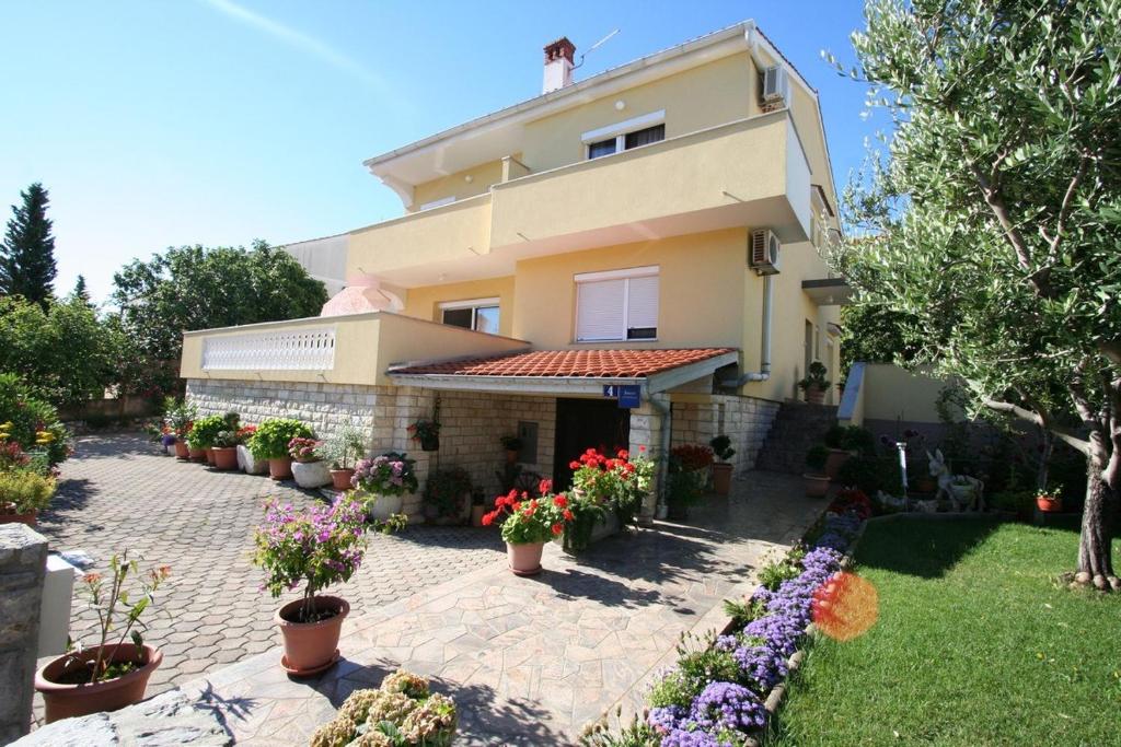 a house with potted plants in front of it at Apartment in Silo/Insel Krk 13439 in Šilo