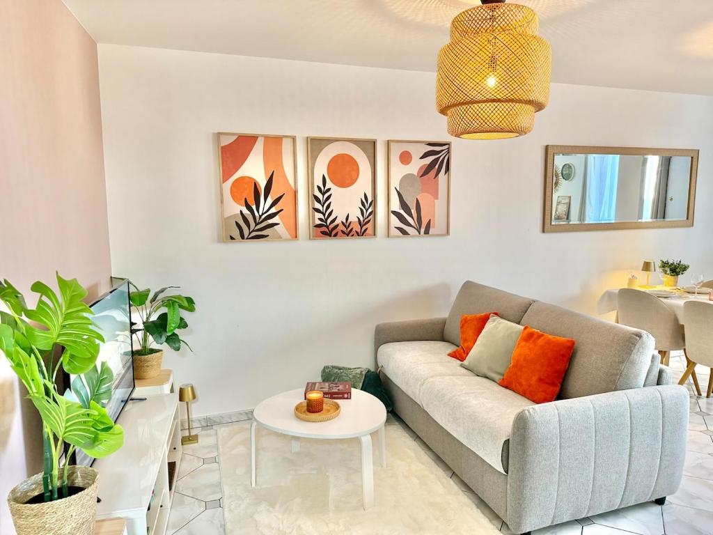 a living room with a couch and a table at Maison Bellebat - proche d'Orleans in Orléans