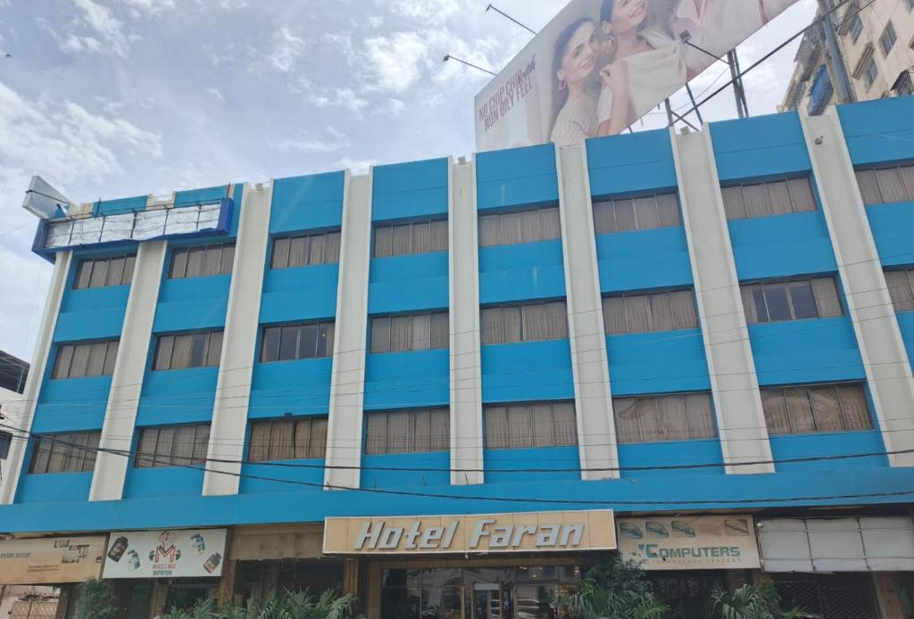 a building with a billboard on the side of it at Faran Hotel in Karachi