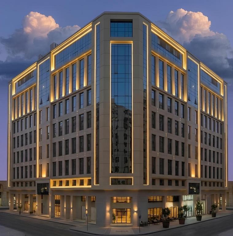 a large office building with a lot of windows at VALY Al-Madinah Hotel in Medina