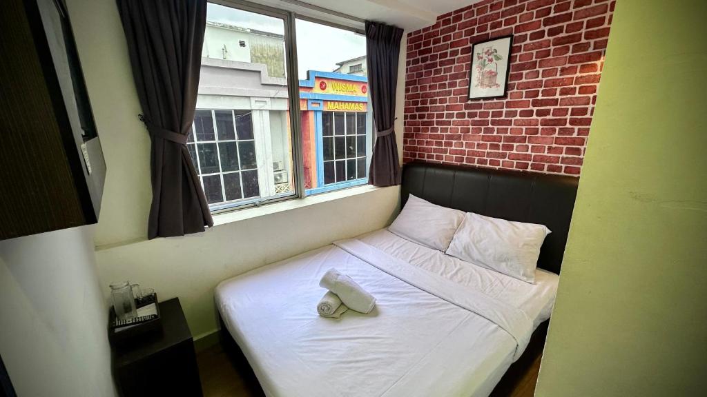 a bed with a pair of shoes on it in a bedroom at Swing & Pillows - Sentul Titiwangsa in Kuala Lumpur