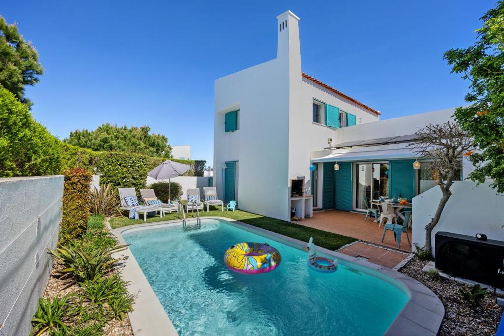 a swimming pool in the backyard of a house at V-Blue in Alvor