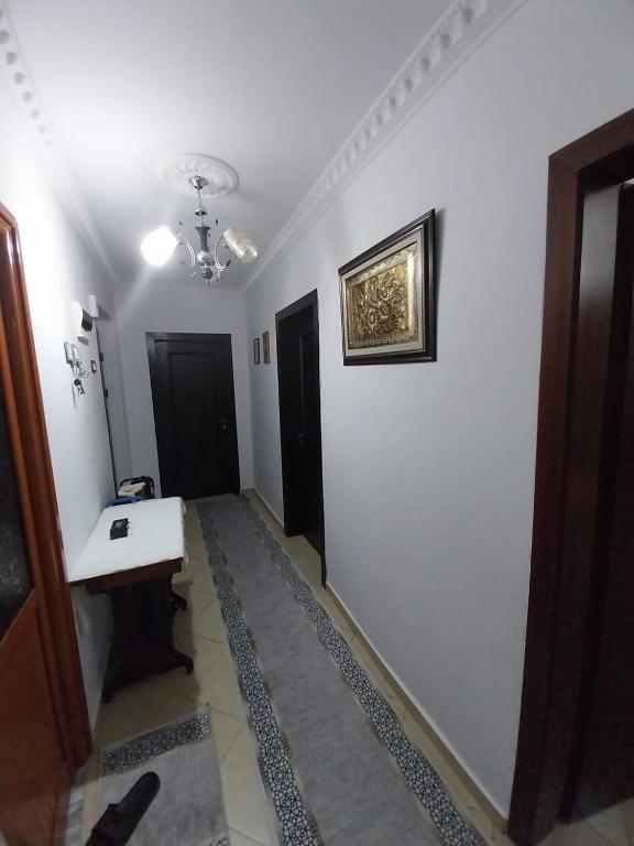 a hallway with a white wall and a sink at Refika in Berat