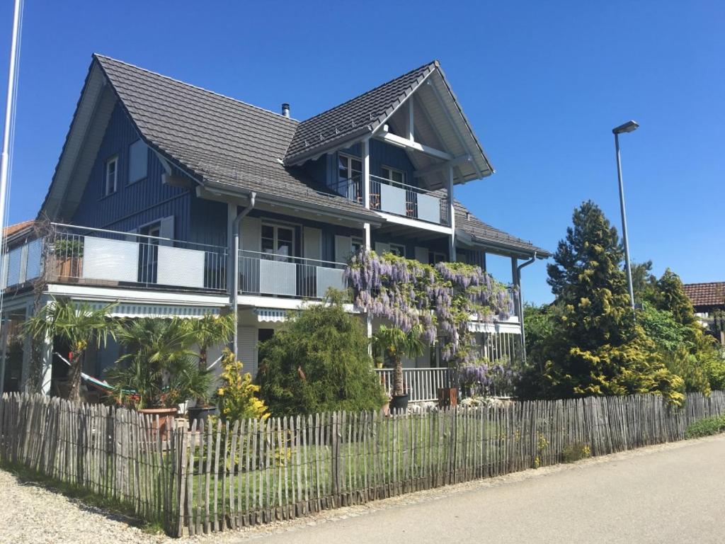 a house with a fence in front of it at Apartment with charm and dream view in Hosenruck