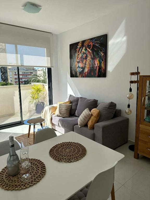 a living room with a couch and a table at Prestige Sunny Terrace Apartment - Torrevieja in Torrevieja