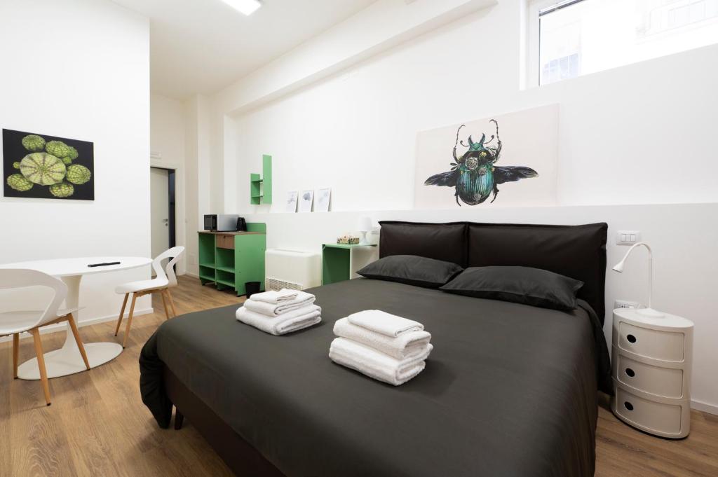 a bedroom with a bed with towels on it at Ospitalità Il Prato in Iesi