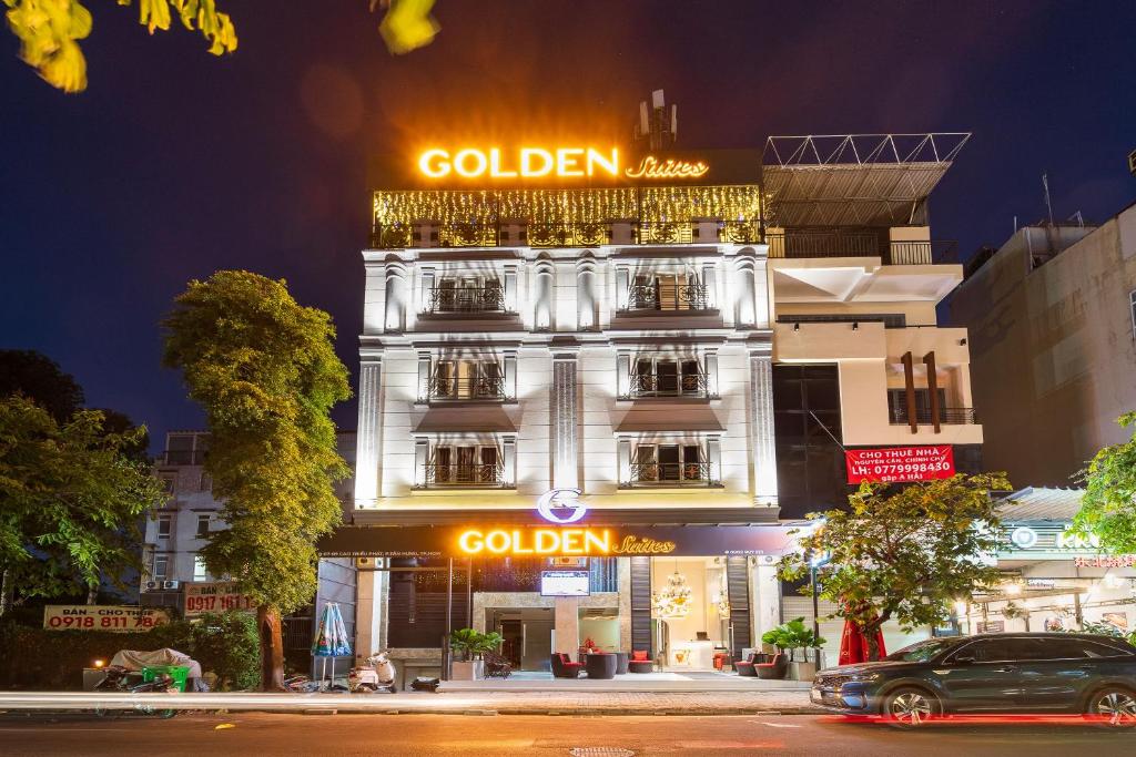 a building with a gold sign on the side of it at Golden Suites Saigon in Ho Chi Minh City
