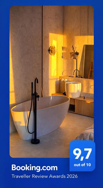a bathroom with a large tub and two sinks at TULUM APARTAMENT-Top Design-FREE GARAGE-BATH-Projector-View-GYM-Wine-Next to SPODEK, MCK, NOSPR in Katowice