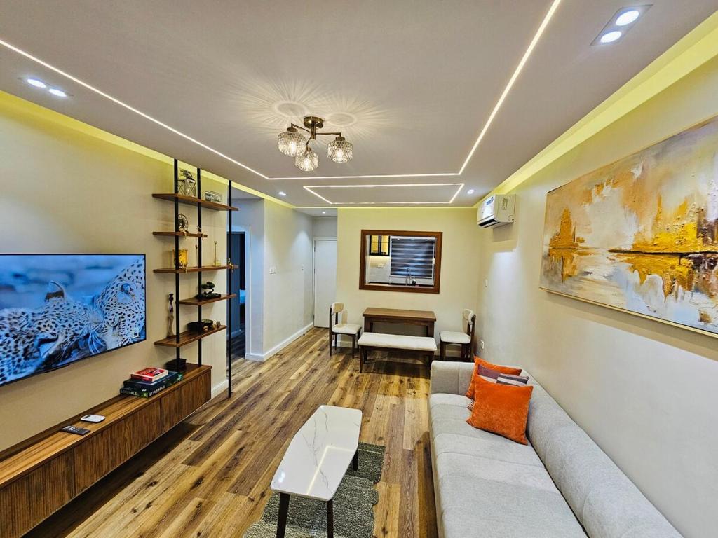 a living room with a couch and a table at Luxe Flat Light in Mama