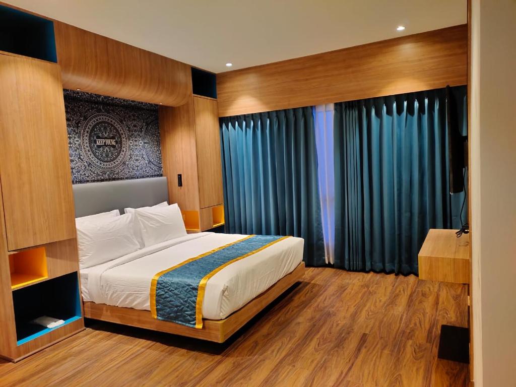 a bedroom with a bed and a large window at Zone by The Park Darjeeling in Darjeeling