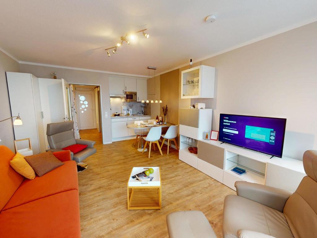 a living room with a couch and a tv at Nautic - 307 in Cuxhaven