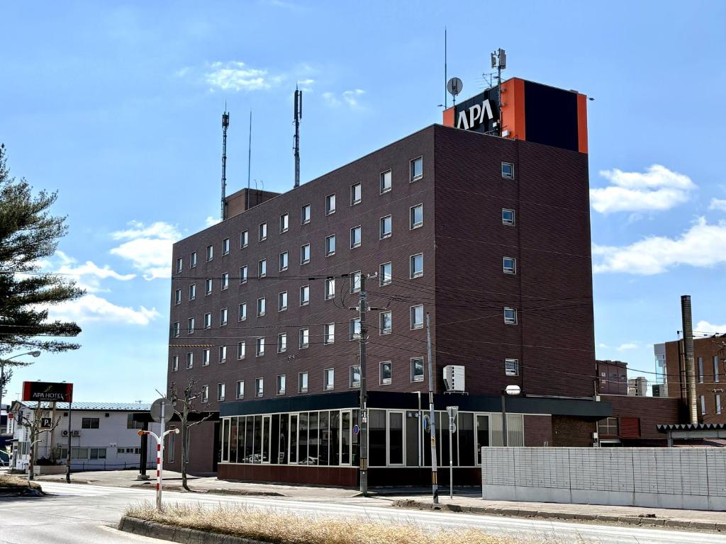 a brown building with a sign on top of it at APA Hotel Okhotsk Kitami in Kitami