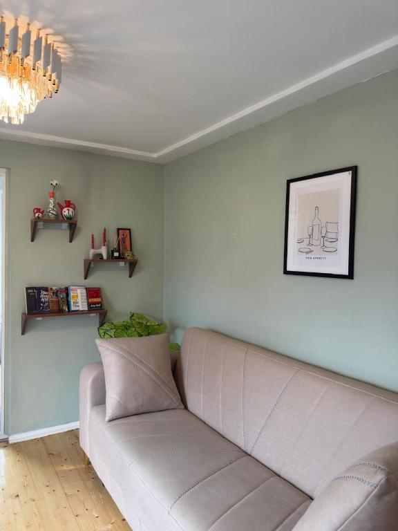 a living room with a couch and a chandelier at Lankaran Boutique Home in Lankaran