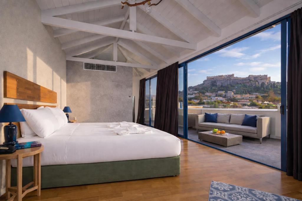 a bedroom with a large bed and a large window at Lotus Center Inn in Athens