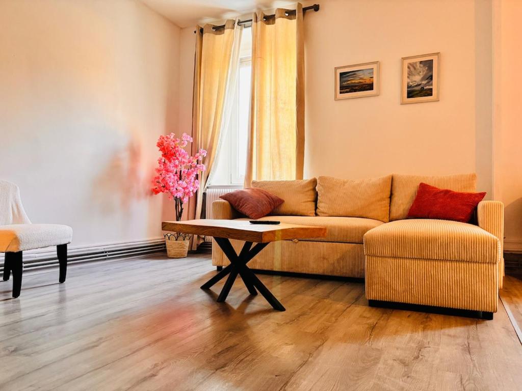 a living room with a couch and a table at Votre cocon vosgien in Saint-Étienne-lès-Remiremont