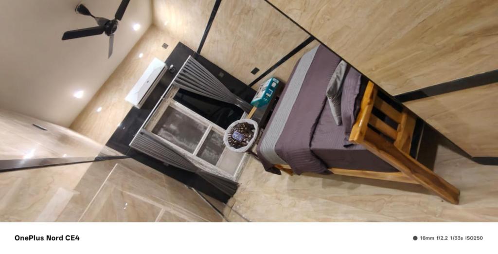 an overhead view of a room with a bed and a microwave at Dr Rajam's Gastro Garden in Vallam