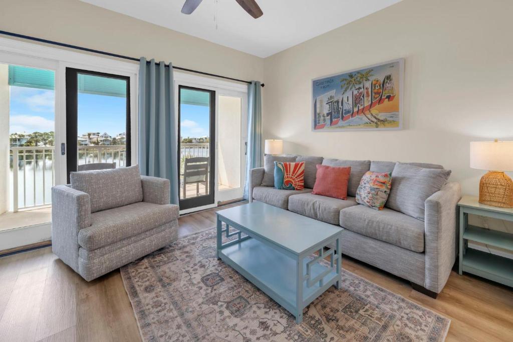 a living room with a couch and a chair and a table at Carillon Beach Inn 310 in Panama City Beach