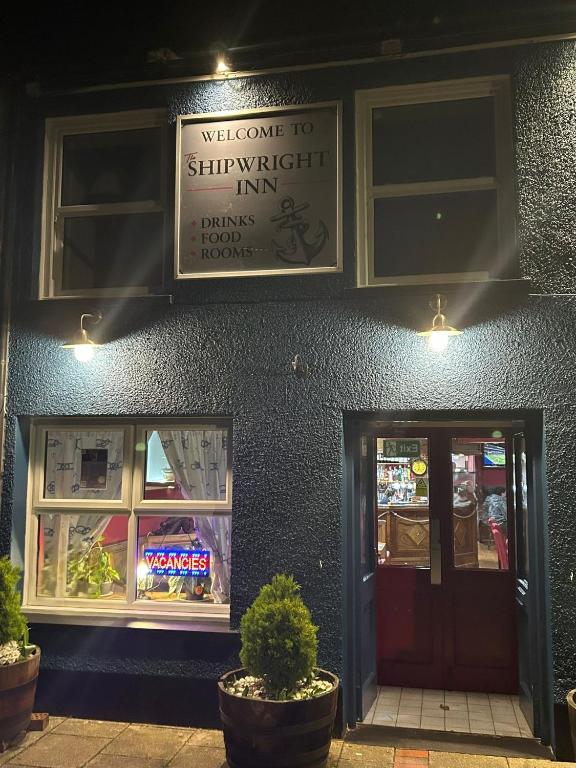 a building with a sign for a subway inn with a door at Shipwright Inn in Pembroke Dock