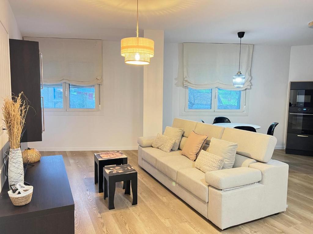 a living room with a white couch and a table at Ribeira Sacra Ledicia in Chantada
