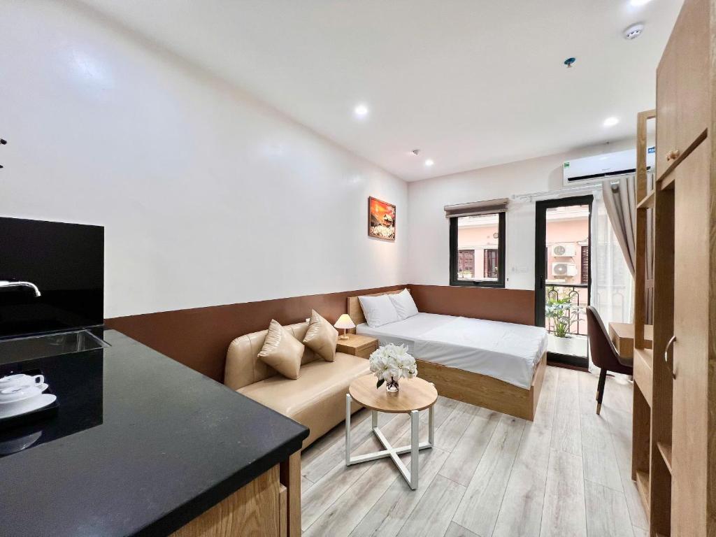 a living room with a couch and a bed at Aurora Homestay in Hanoi
