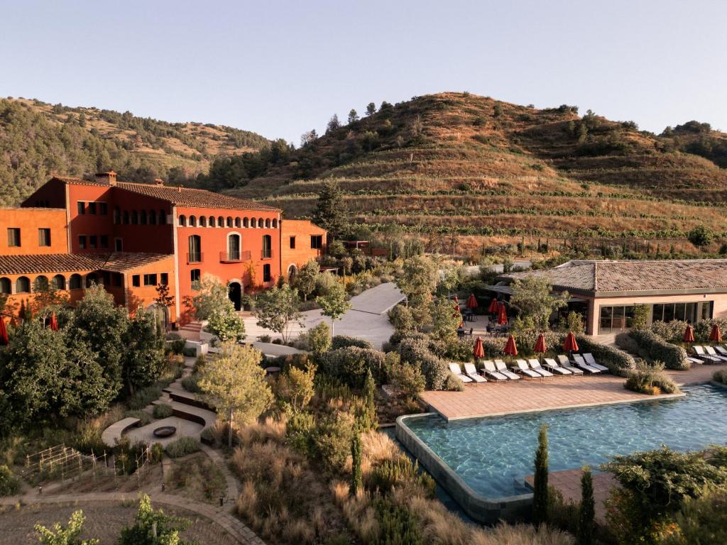 a resort with a mountain in the background at Gran Hotel Mas d'en Bruno in Gratallops