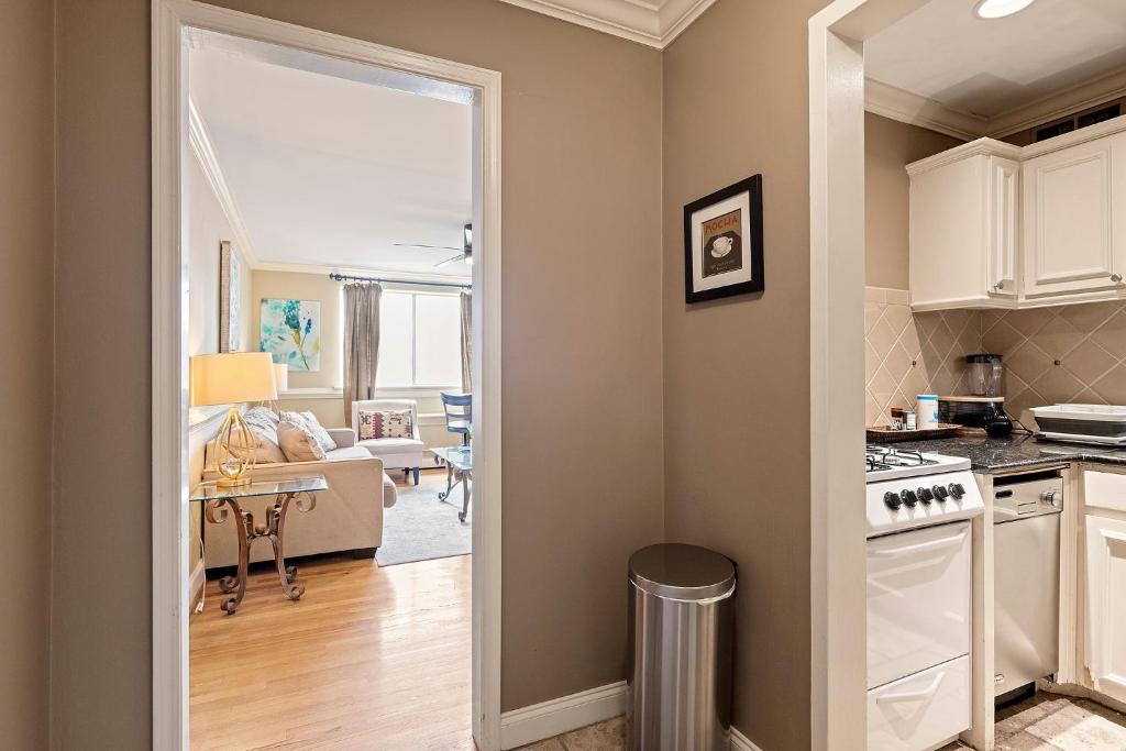 a kitchen and a living room with a table at Prime Location 1BR Near Top Attractions & Stadiums with Free Parking-1204 in Atlanta