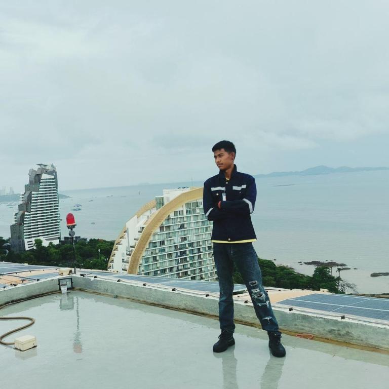 a man standing on the roof of a building at Wai zin in Sara Buri