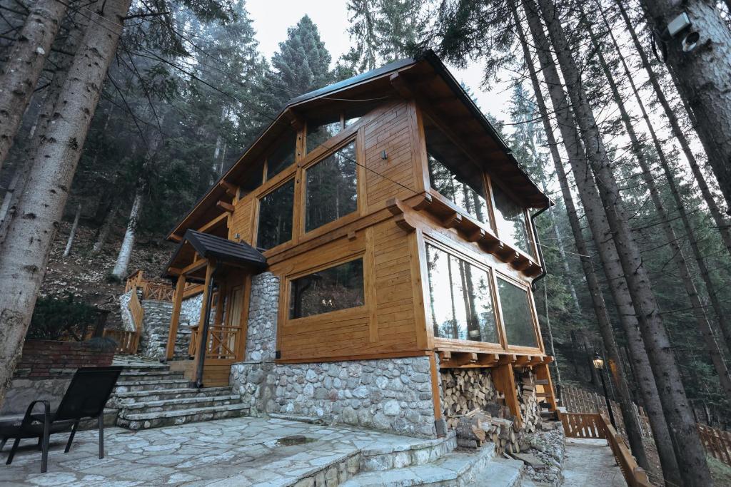 a log cabin in the woods with trees at Seraphine Chalet in Peje