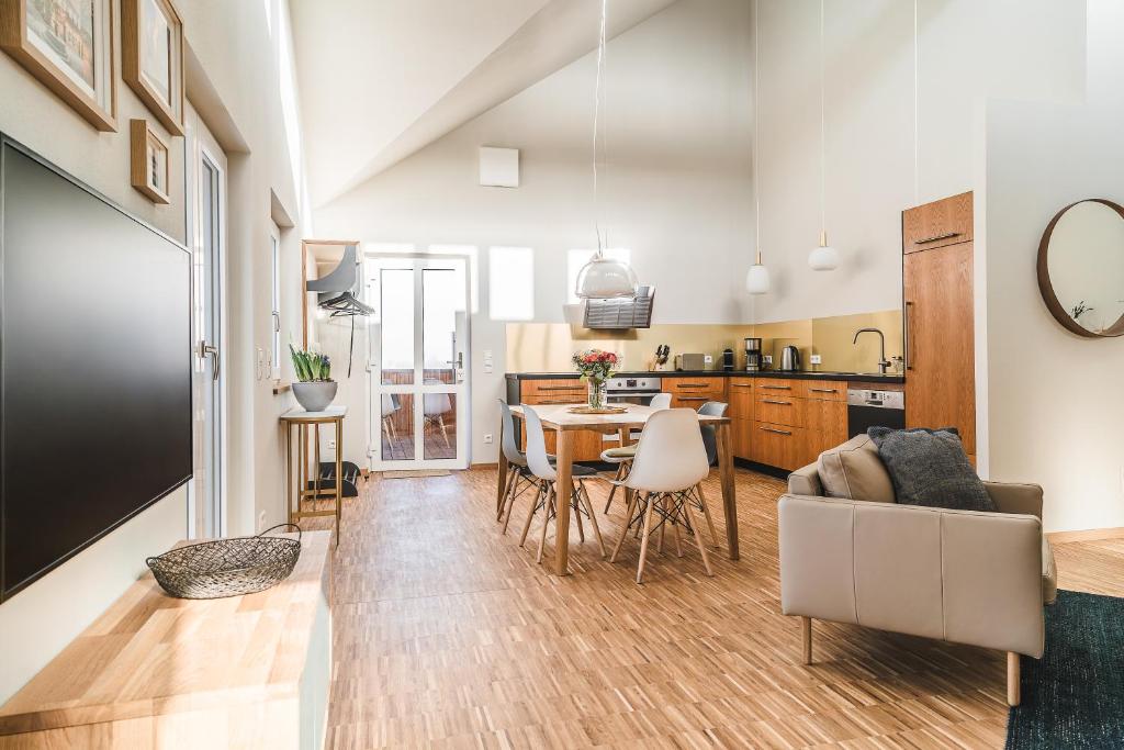 a kitchen and living room with a table and chairs at Maison Bellevue in Westendorf