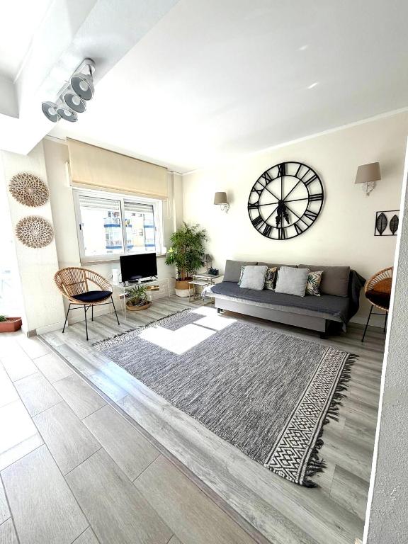 a living room with a couch and a rug at Beachome4u in Carcavelos