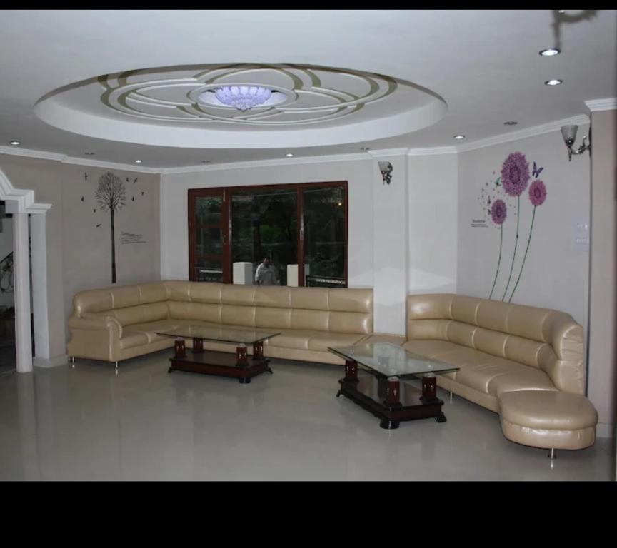 a living room with a couch and two tables at Raj Palce in Kasol
