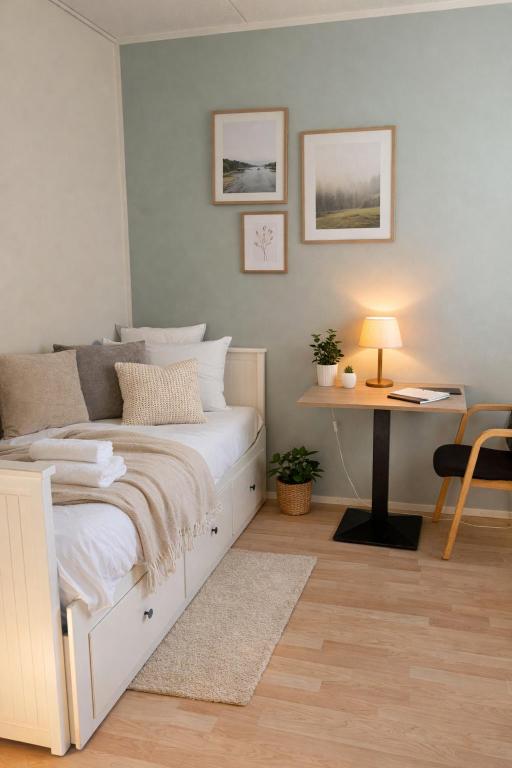 a bedroom with a white bed and a desk at Quiet Private Rooms Easy Metro & Airport Access in Vantaa
