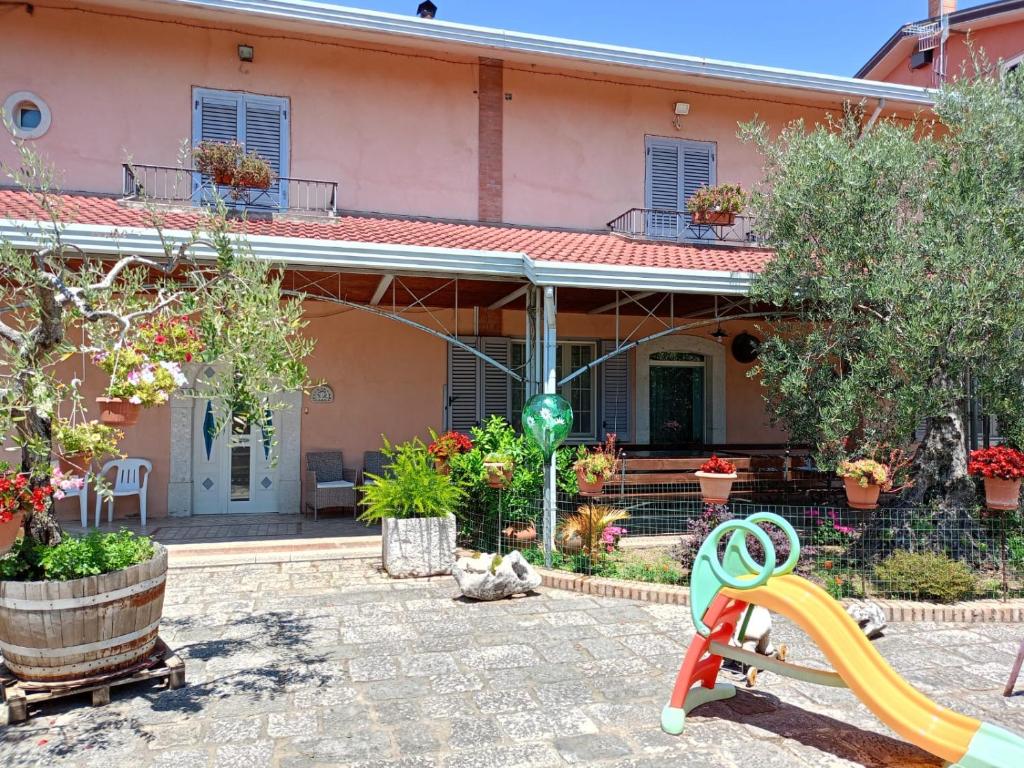 a house with a playground and a slide at Masseria Sant' Anna in Cerreto Sannita
