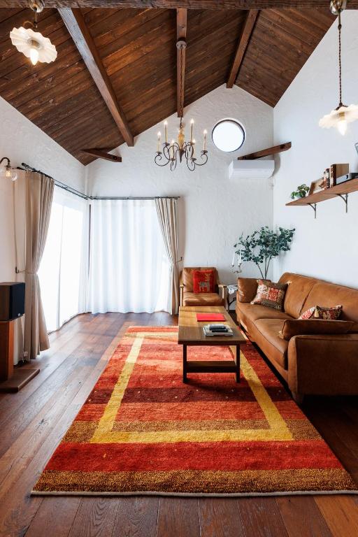 a living room with a couch and a table at Villa Ferme Yatsugatake in Hokuto