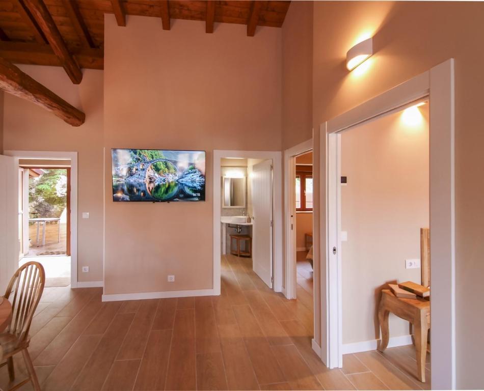 a living room with a flat screen tv on the wall at APARTAMENTOS PUENTEDEY in Puentedey