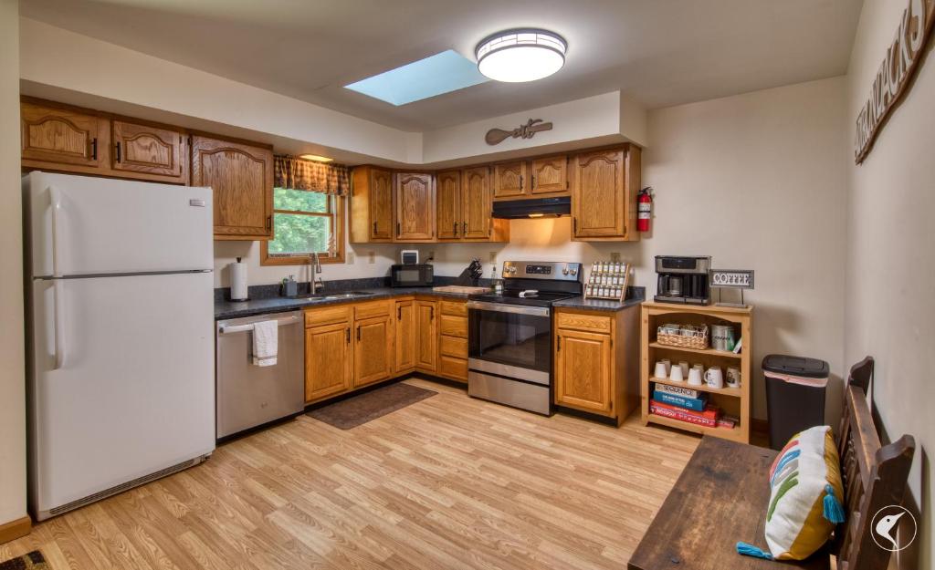 a kitchen with wooden cabinets and a white refrigerator at Lawrences Hideaway in Wilmington