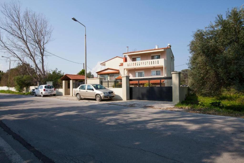 a house with two cars parked in front of a street at Natural Quiet Accommodation 3 - Faliraki in Kalithies