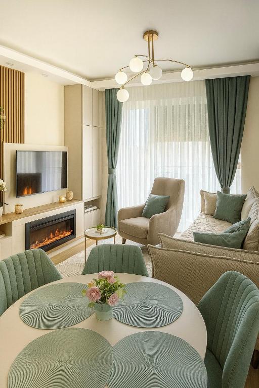 a living room with two tables and a couch at Panorama GOLD Vrnjačka Banja in Vrnjačka Banja
