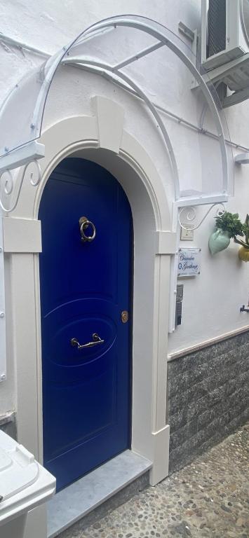 a blue door in a building with an arch at Chianalea Guesthouse in Scilla