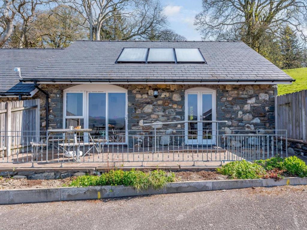 a stone house with a porch and a patio at 2 Bed in Bala oc-86963 in Llandderfel