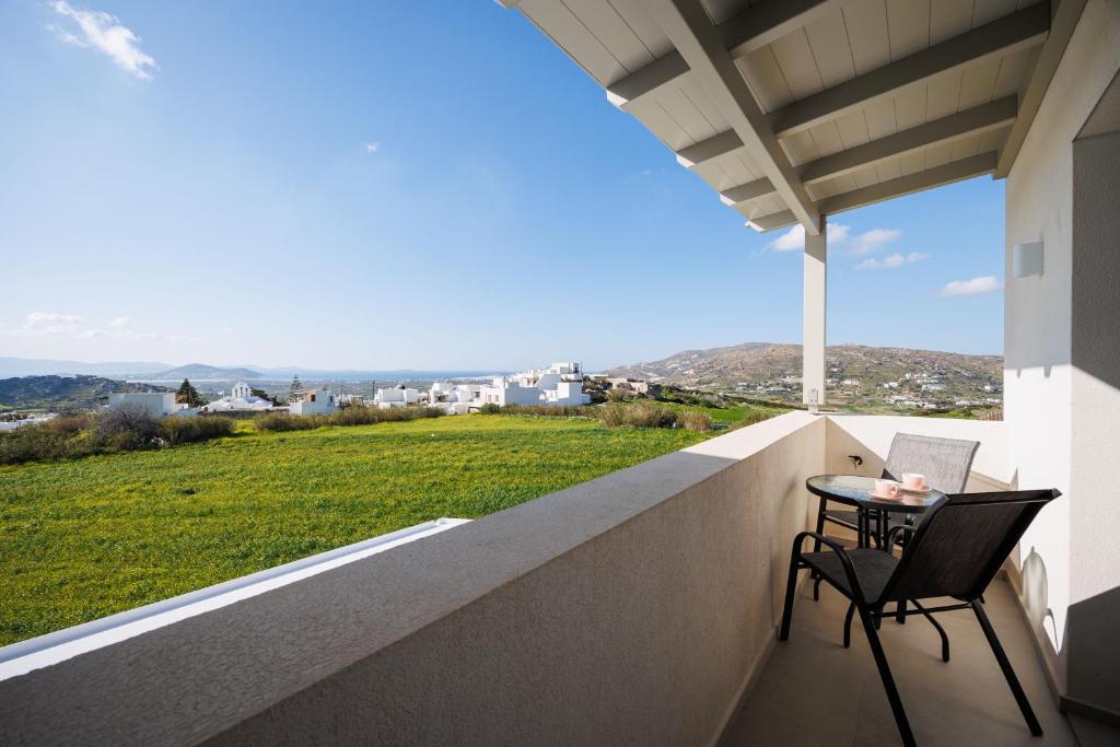 a balcony with a table and chairs and a view at Etherio Apartments Naxos in Galanádhon