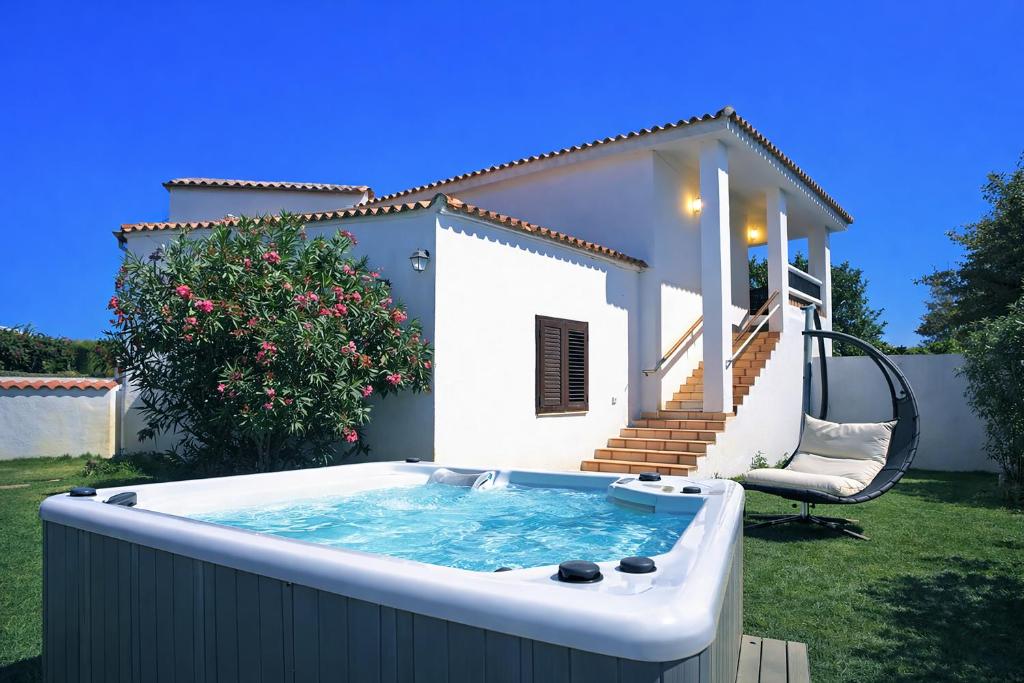 a hot tub in the backyard of a house at La Conia Sea View Retreat in Cannigione