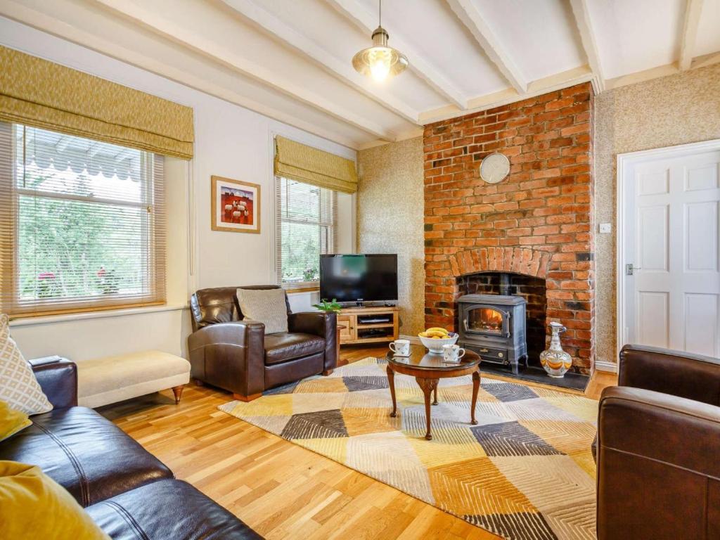 a living room with a couch and a fireplace at 3 Bed in Bala oc-88351 in Frongoch