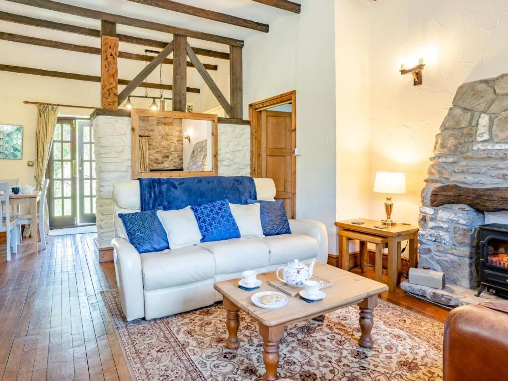 a living room with a couch and a fireplace at 1 Bed in Swansea oc-77980 in Penclawdd