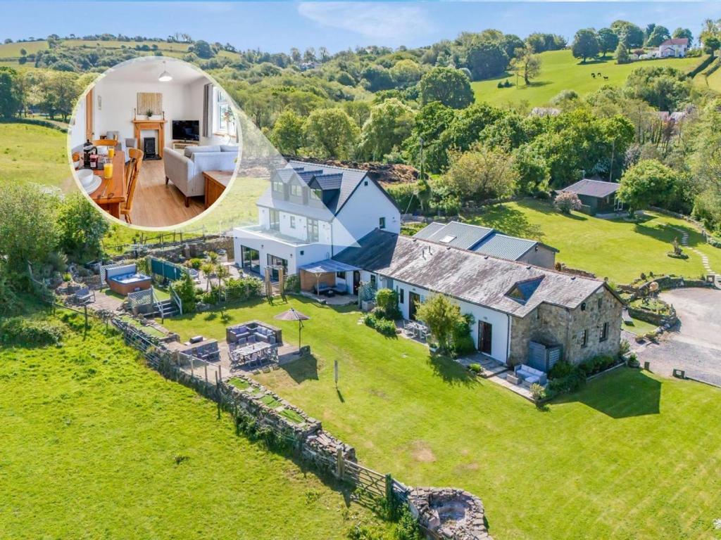 an aerial view of a house on a green field at 2 Bed in Swansea oc-77978 in Penclawdd
