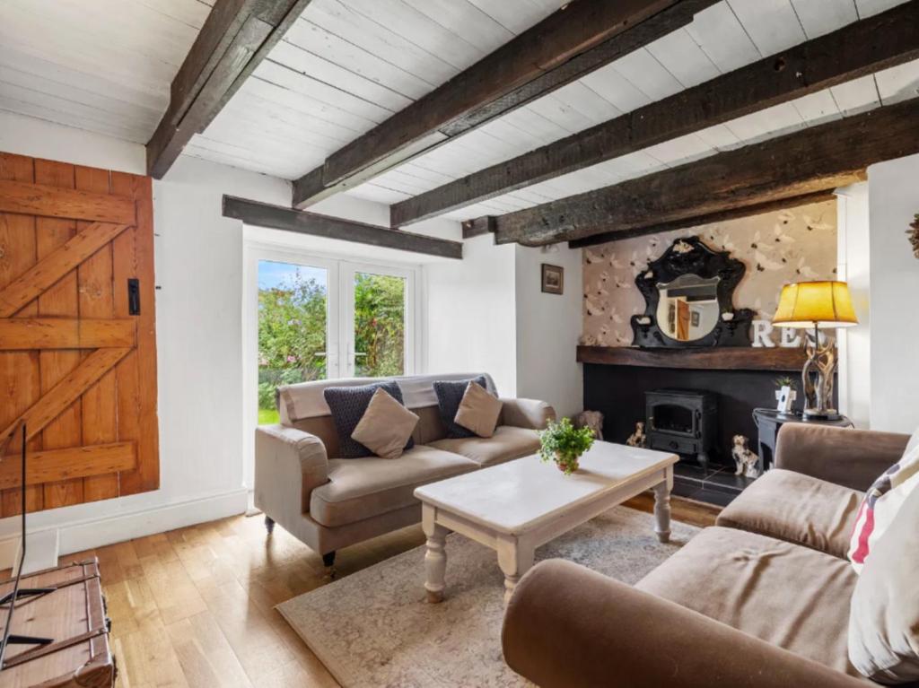a living room with two couches and a fireplace at 2 Bed in Swansea oc-88216 in Port-Eynon